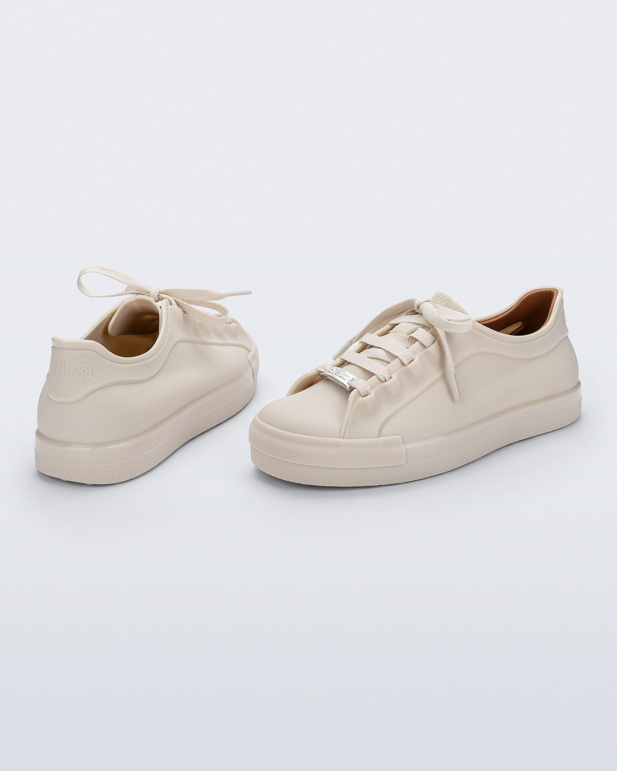 Back and angled view of a pair of beige Wow Sneakers with beige laces