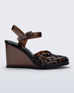 Side view of a clear brown Agata wedge heel sandal with ankle strap