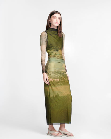 Model in green dress wearing a pair of beige Sun Samba thong sandals