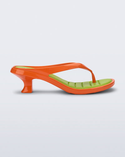 Side view of a orange Flip Flop Kitten Heel with  green insole