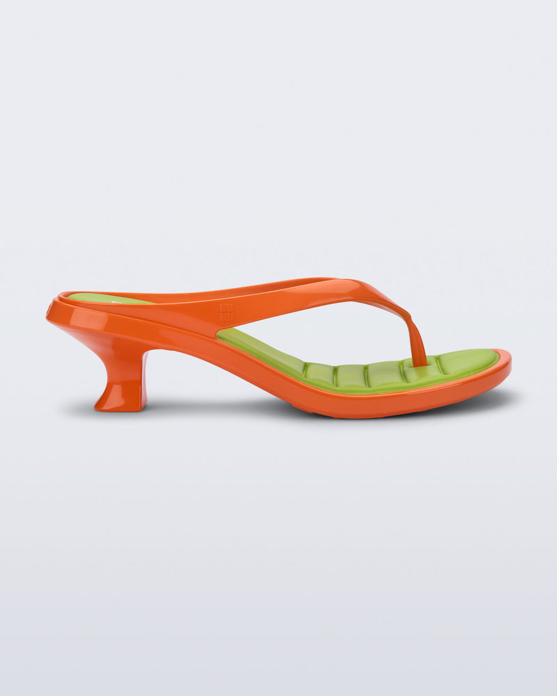 Side view of a orange Flip Flop Kitten Heel with  green insole
