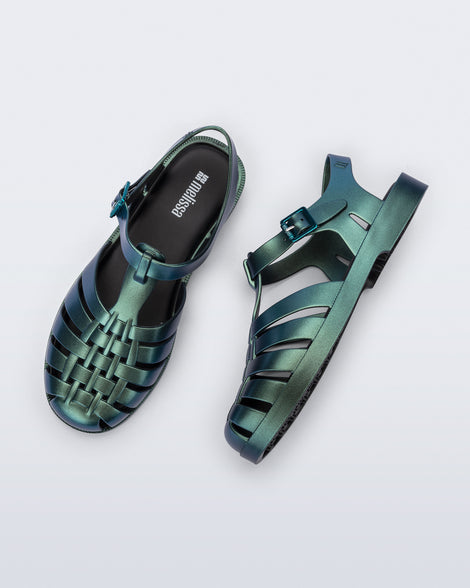 Top and side angled view of a pair of metallic magic green Possession Fisherman sandals
