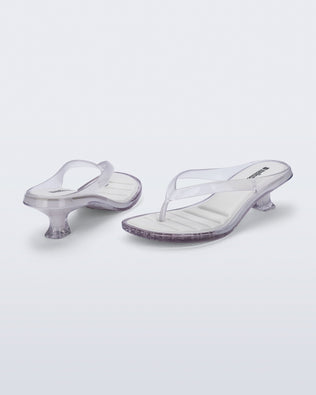 Back and angled view of a pair of clear Flip Flop Kitten Heels with white insole