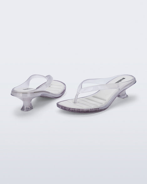 Back and angled view of a pair of clear Flip Flop Kitten Heels with white insole