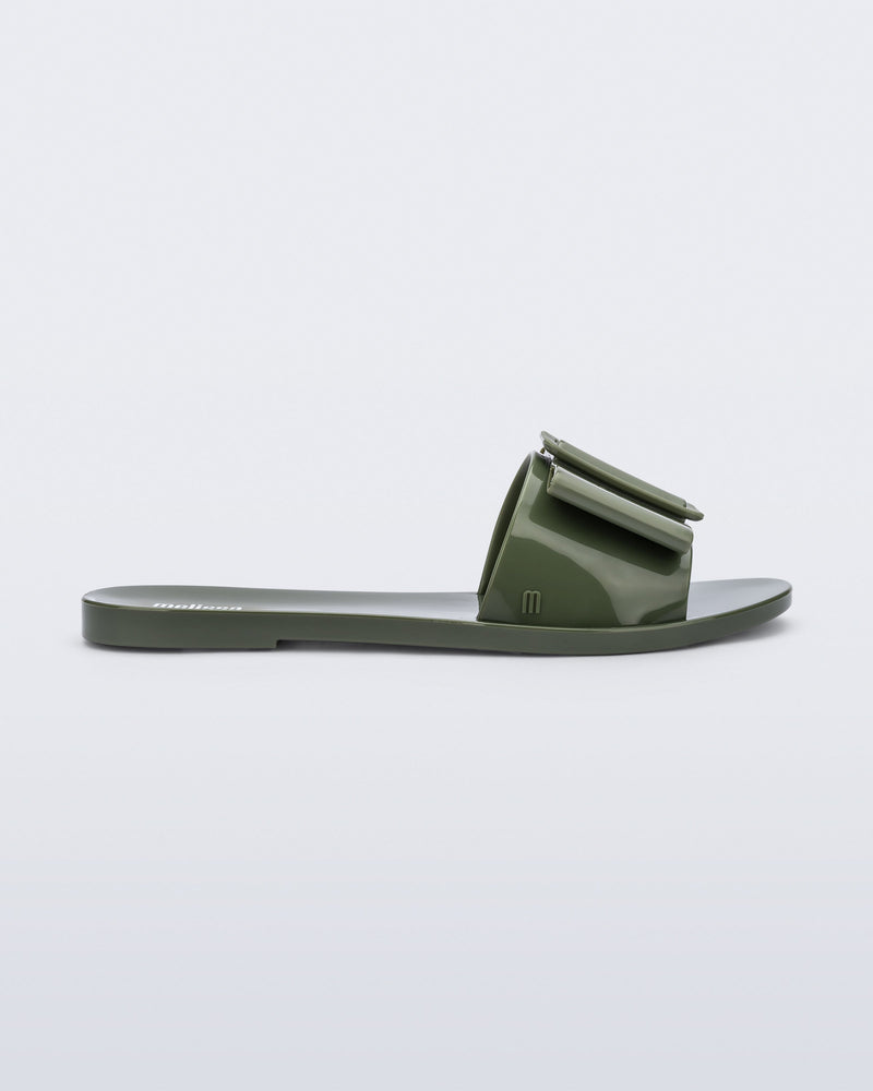 Side view of a dark green Babe slide sandal