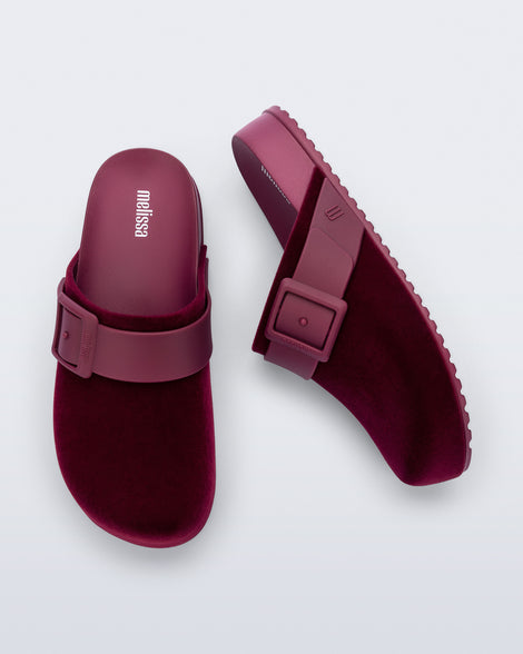 Top and side view of a pair of red Cozy Clog Velvet slides