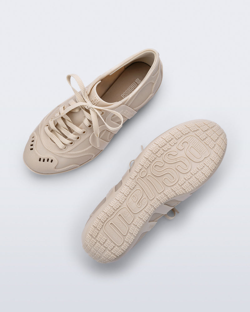 Top and bottom view of a pair of beige Motion Sneakers