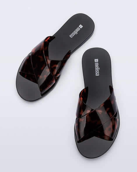 Top view of a pair of black Essential Cross Slide sandals with tortoise colored straps