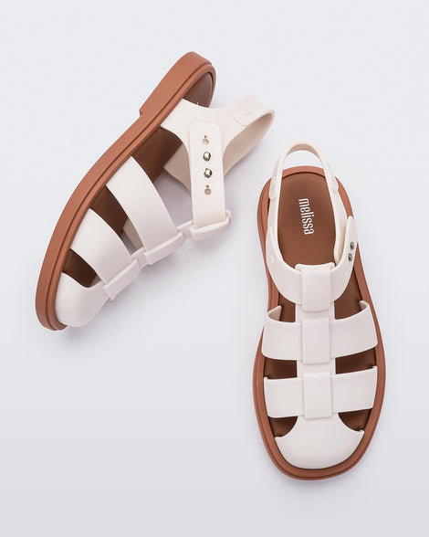 Side and top view of a pair of beige Emma women's sandals with brown sole.