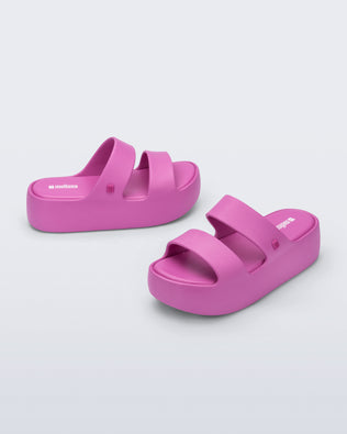 Angled and side view of a pair of pink Free Line Platform slides