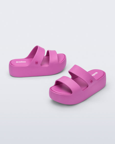 Angled and side view of a pair of pink Free Line Platform slides