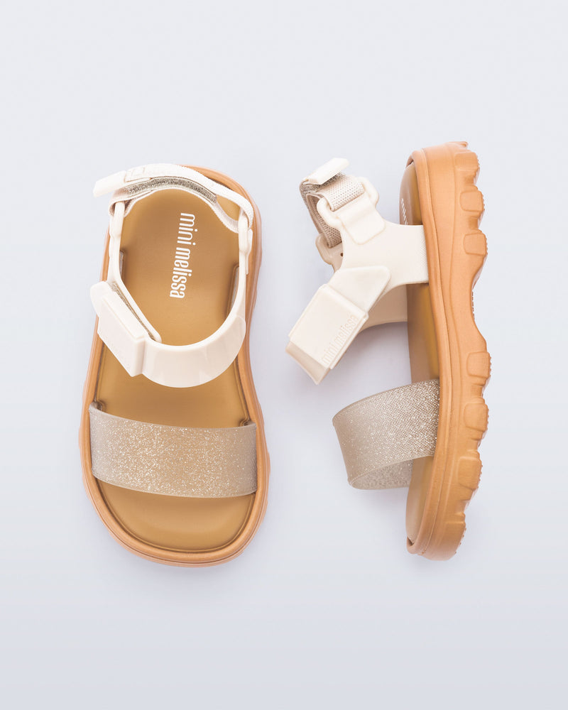Top and side view of a pair of beige/glitter Kick Off baby sandals