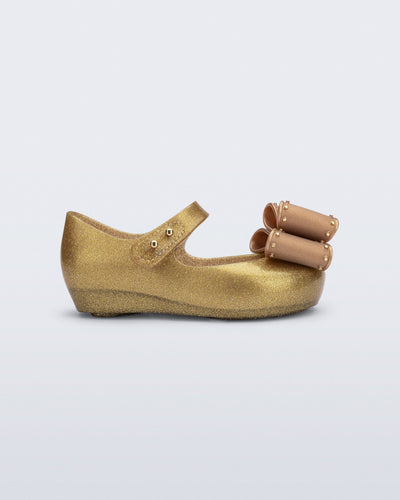 Side view of a pearly beige baby Ultragirl Classic Bow flats