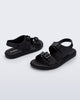 Side and angled view of a pair of black Wave Sandals with two straps with buckles and a back strap