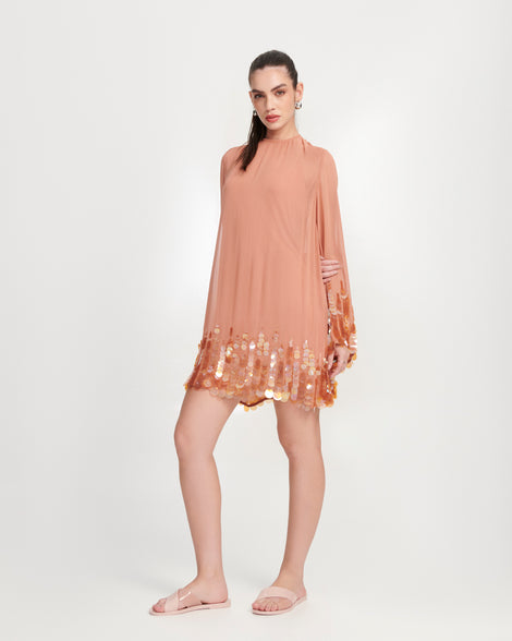 Model in an orange dress wearing a pair of pink Essential Cross Slide sandals