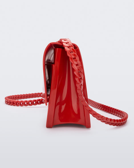 Side view of the Melissa party handbag in red with braided strap.