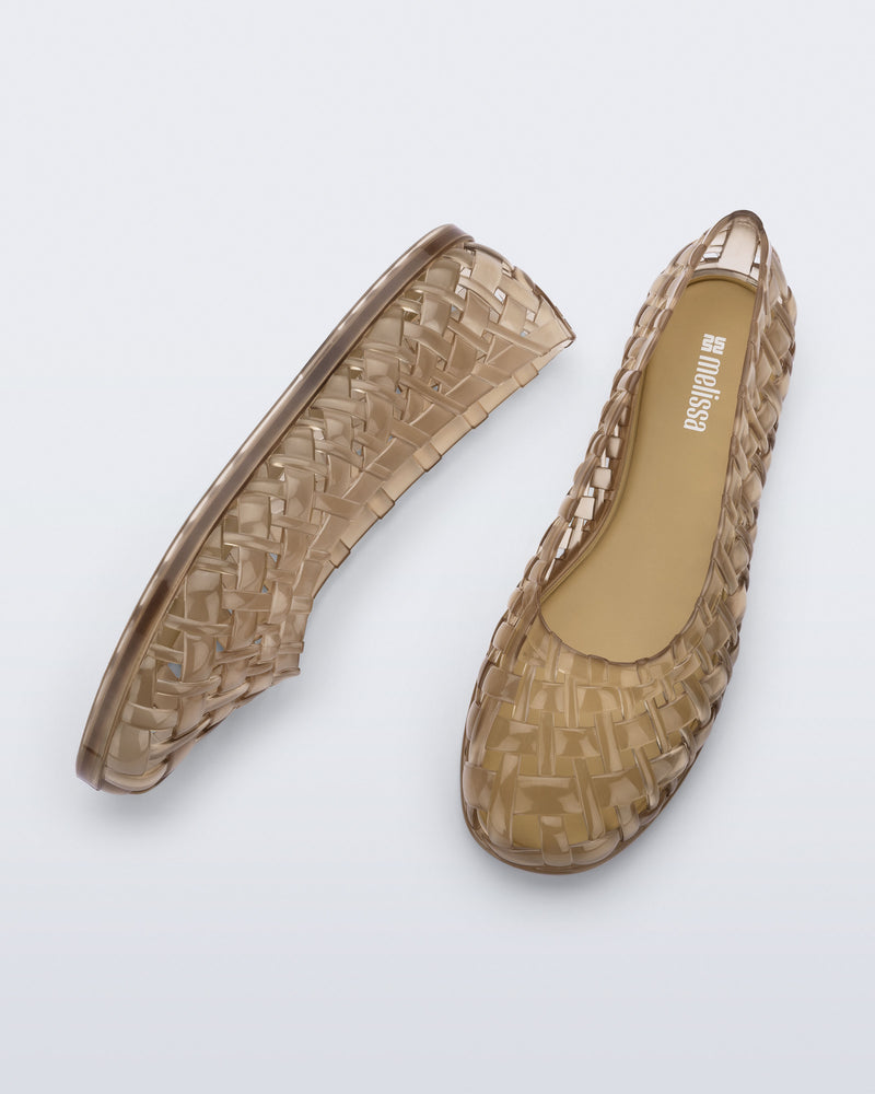 Side and top view of a pair of beige Possession Ballerina flats