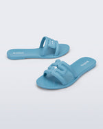 Side and angled view of a pair of blue M Slide sandals