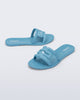 Side and angled view of a pair of blue M Slide sandals