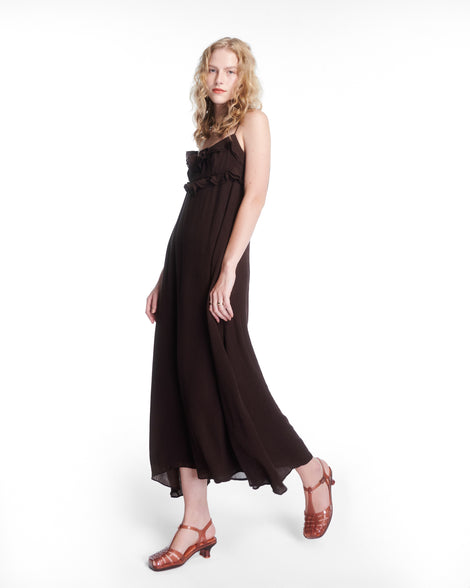 Model in a black dress wearing a pair of clear brown Vixen Kitten Heel Sandals