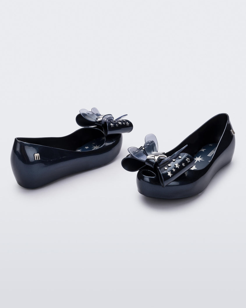 Angled view of a pair of Mini Melissa Ultragirl peeptoe ballet flats in blue with star printed butterfly bow applique. 