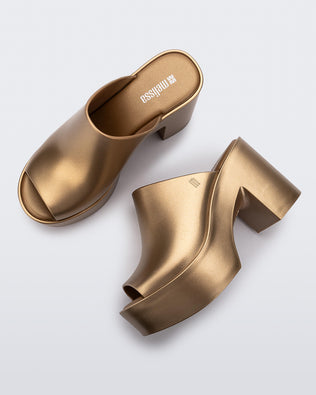 Top and side view of a pair of gold Mule Hype Platforms