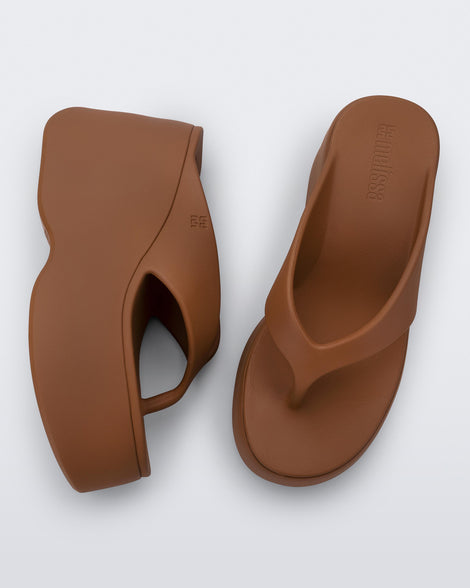 Top and side view of a pair of brown Free Thong Wedge platform flip flop sandals