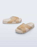 Side and angled view of a pair of beige Cozy M Lover Slides with Melissa on the upper