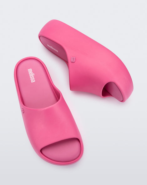 Top and side view of a pair of pink Free Platform women's slides