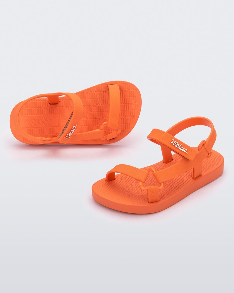 Top and angled view of a pair of orange Sun Downtown baby sandals
