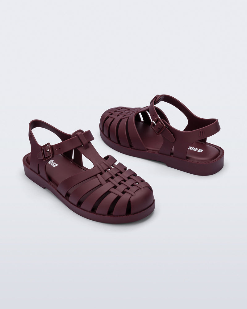 Front and back angled view of a pair of matte burgundy Possession fisherman sandals.