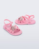 Side and angled view of a pair of pearly pink Hip Sky baby sandals with a glitter pink star on top