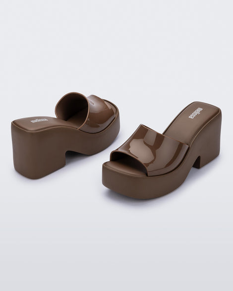 Back and angled view of a pair of brown Posh platform heels