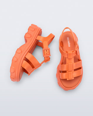 Top and side view of a pair of orange Ella kids sandals