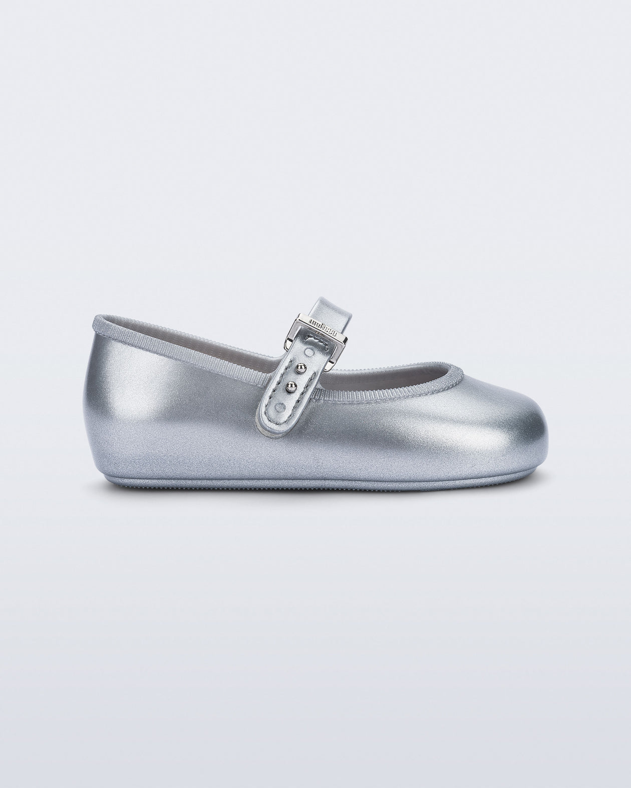 Side view of a pair of silver Soft Ballerina baby flat