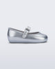 Side view of a pair of silver Soft Ballerina baby flat