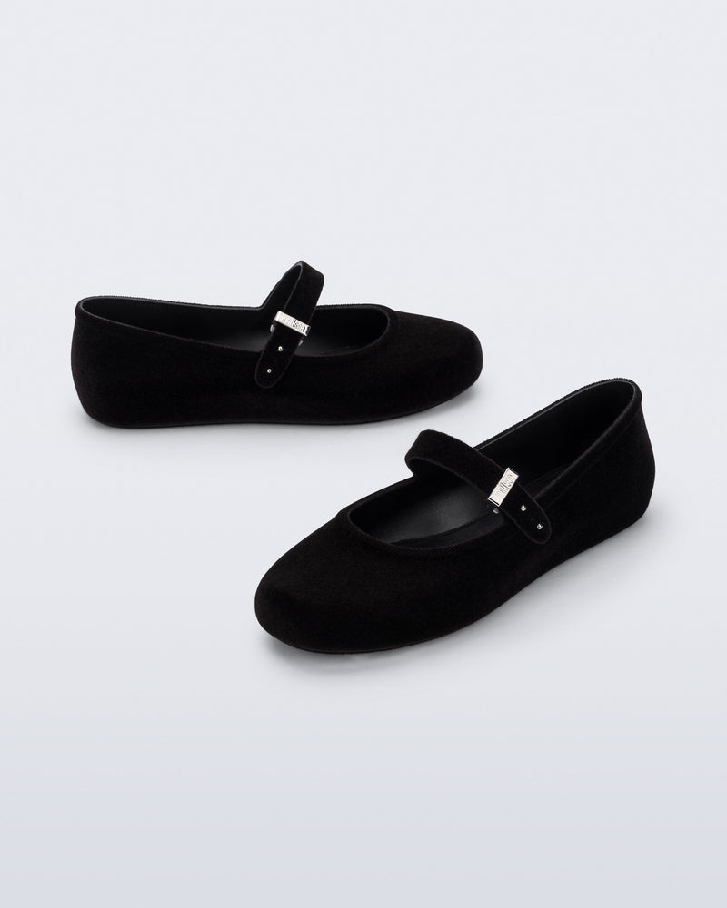 Side and angled view of a pair of black Soft Ballerina Velvet II flats