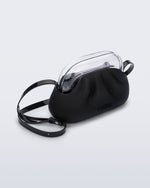 Angled view of a small black bag with clear clutch and long strap