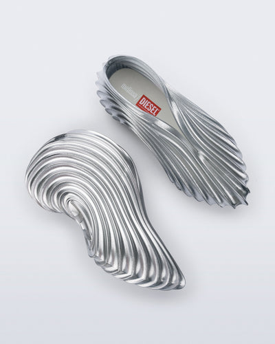 Side and top view of a pair of silver Quantum Sneakers