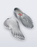 Side and top view of a pair of silver Quantum Sneakers