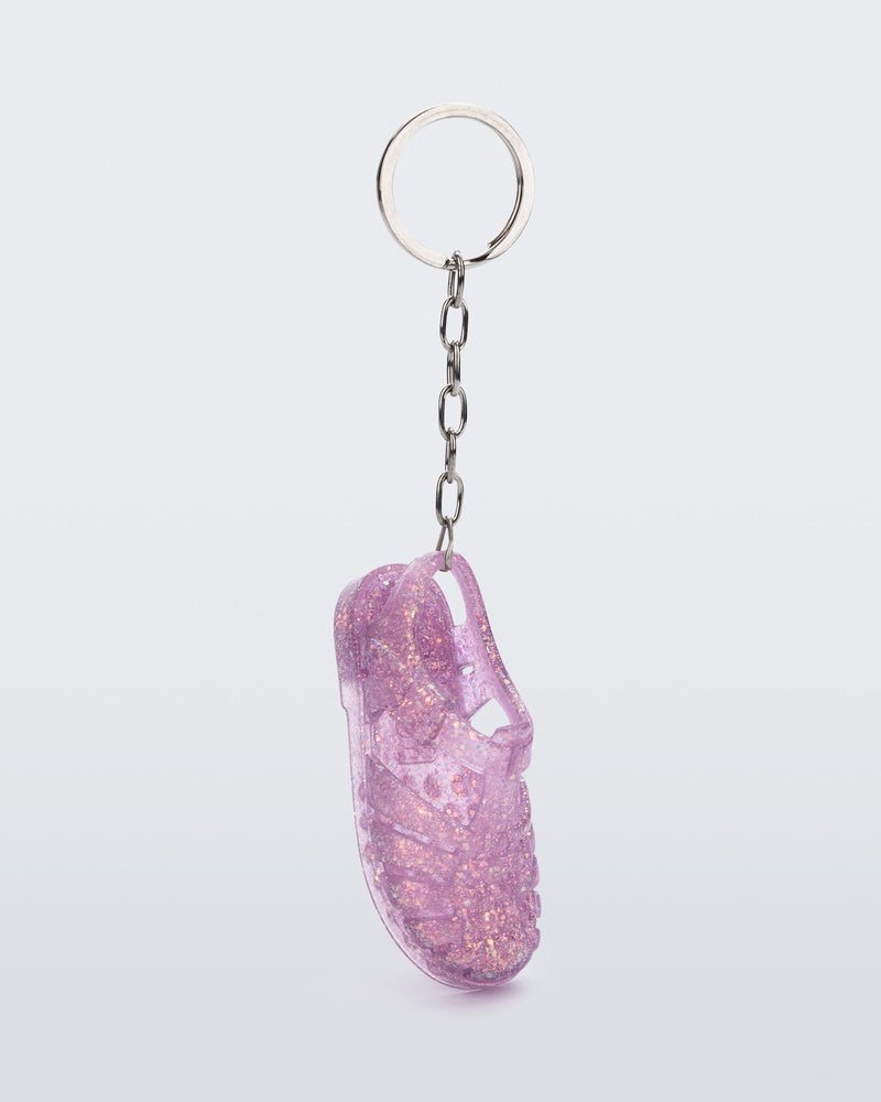 Side angled view of glitter lilac Possession keyring