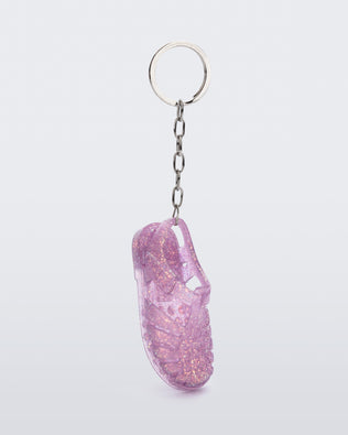 Side angled view of glitter lilac Possession keyring