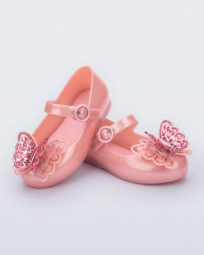 Angled view of a pair of pink Sweet Love Butterfly baby flats
