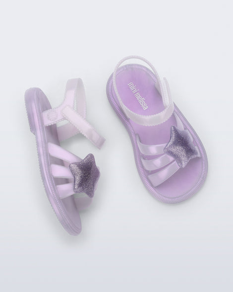 Side and top view of a pair of pearly purple Hip Sky baby sandals with a glitter purple star on top