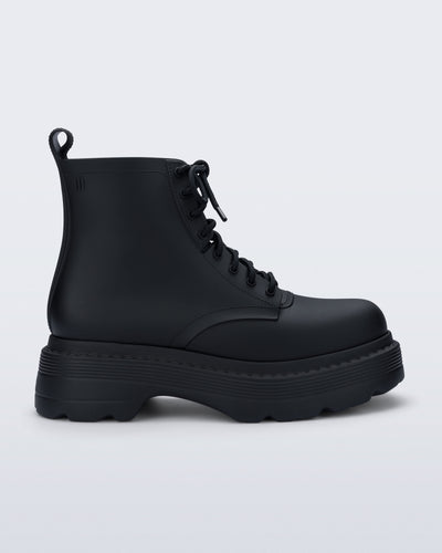 Side view of a matte black Coturno Soft Platform boot