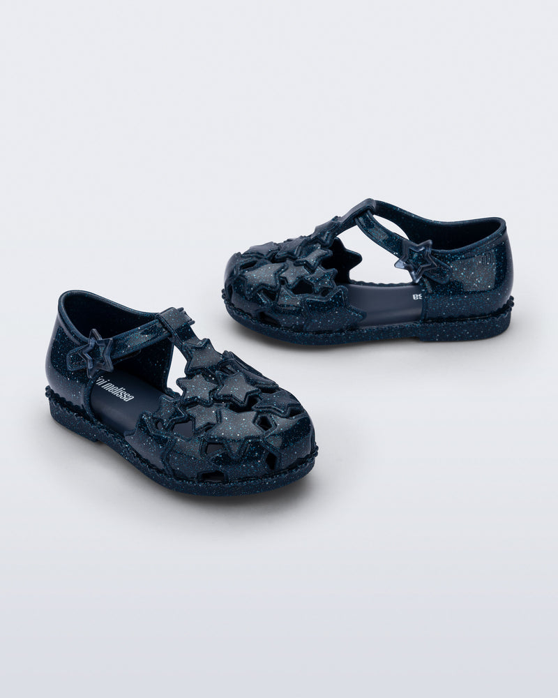Side and angled view of a pair of glitter blue Starry baby sandals