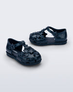 Side and angled view of a pair of glitter blue Starry baby sandals