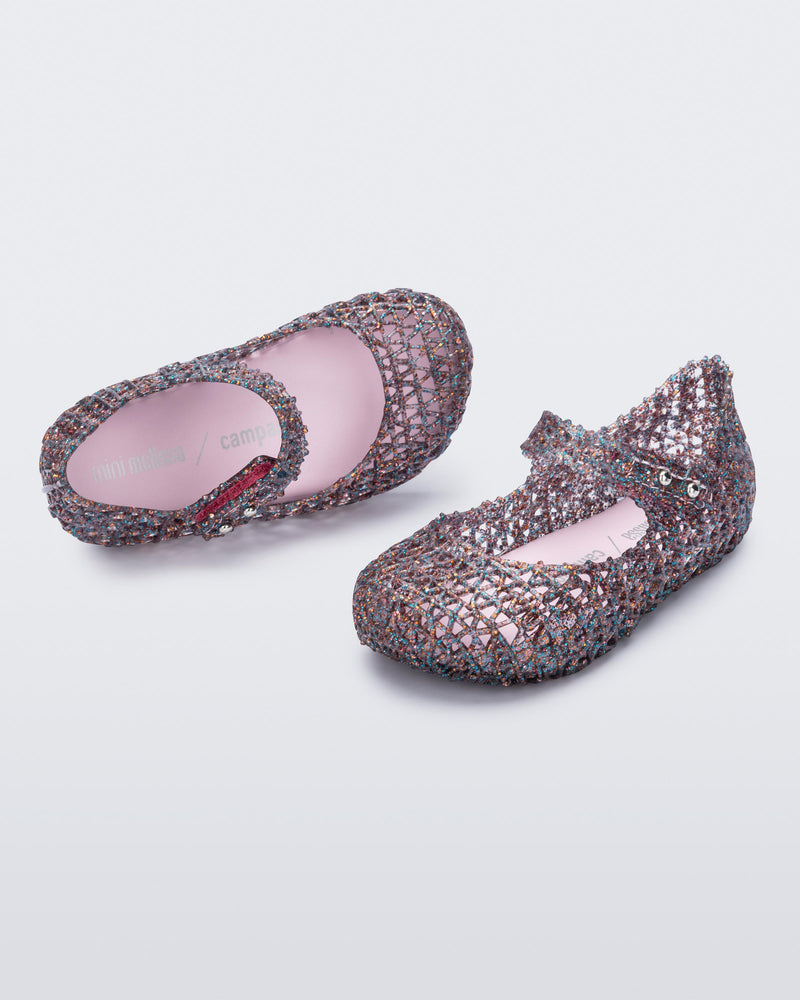 Top and angled view of a pair of glitter clear/pink Campana baby flats