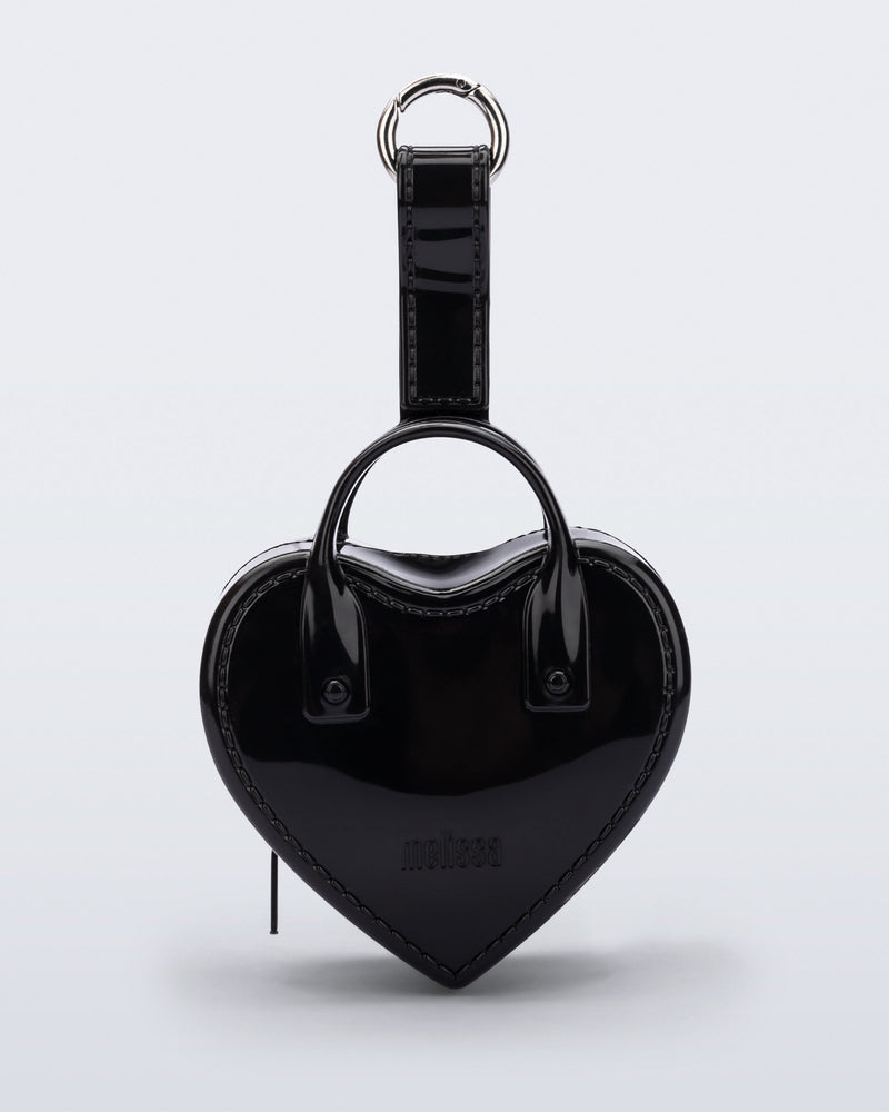 Front view of a black Heartbeat Pocket bag charm
