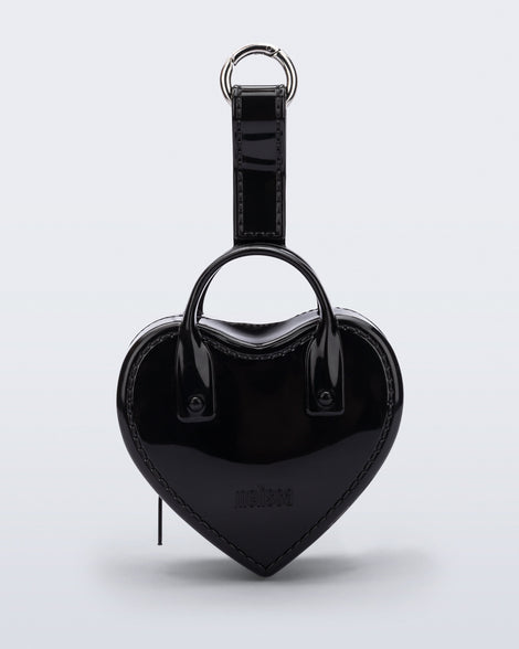 Front view of a black Heartbeat Pocket bag charm